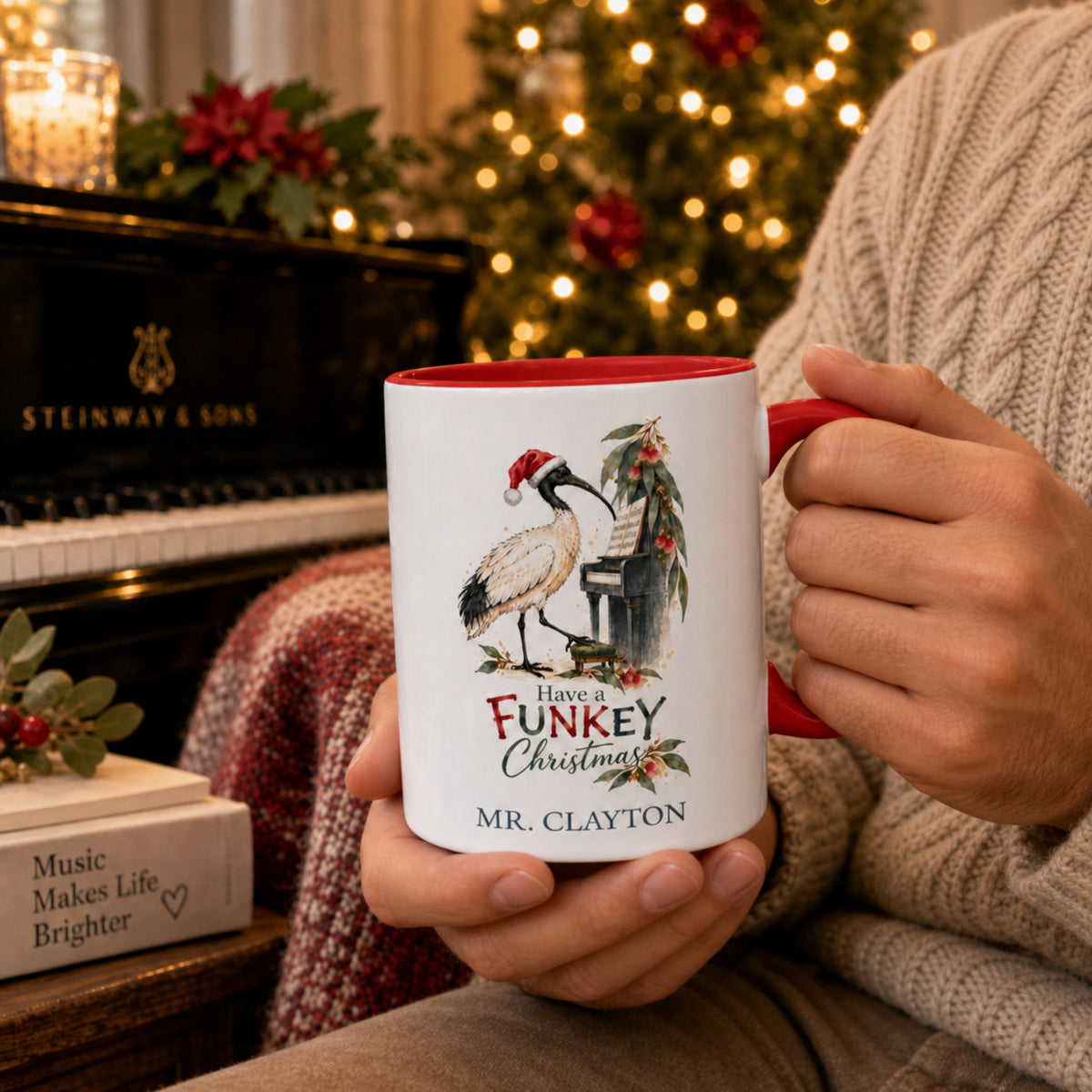 Personalised ibis Christmas mug held beside a piano with festive Australian Christmas setting