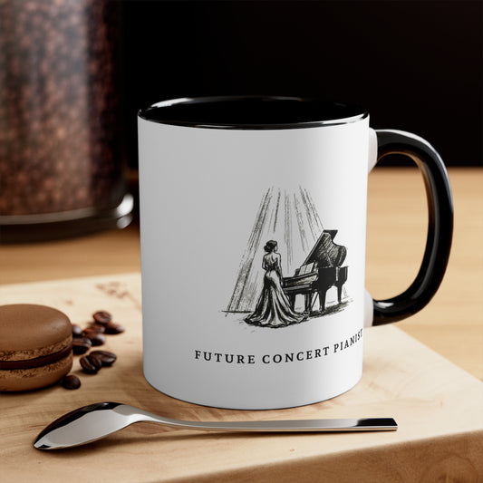 The Ovation piano mug for aspiring pianists on a wooden table beside coffee beans and a spoon with a grand piano in the background.