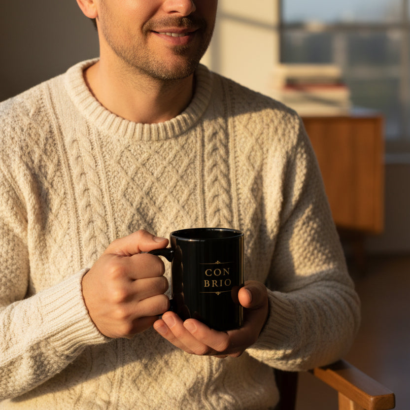 Man holding a Con Brio black piano mug at home