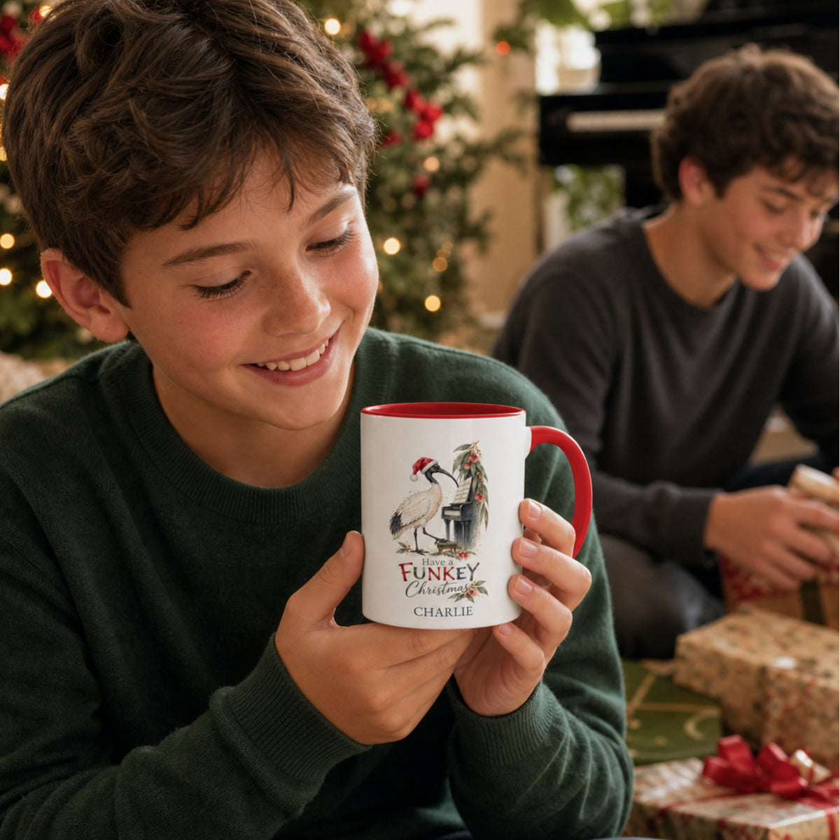 Boy holding a personalised ibis piano Christmas mug with red handle