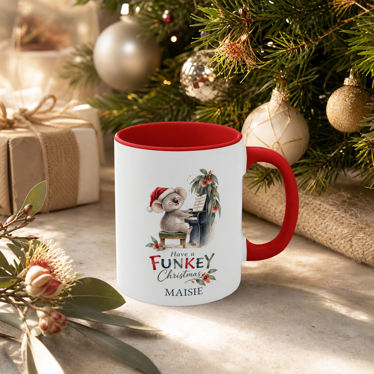 Personalised koala piano Christmas mug styled beside an Australian Christmas tree