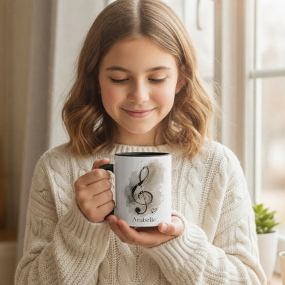Young music student holding the Treble Dreams Arabelle personalised music mug while enjoying a warm drink.
